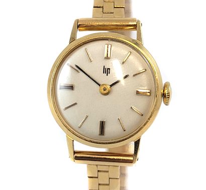 null LIP WATCH holding a round dial, white background, baton index. Mechanical movement...