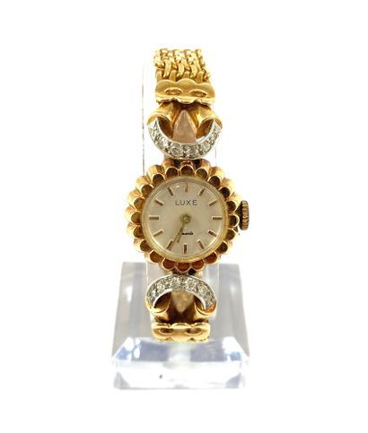 WATCH adorned with a round dial with a floral...