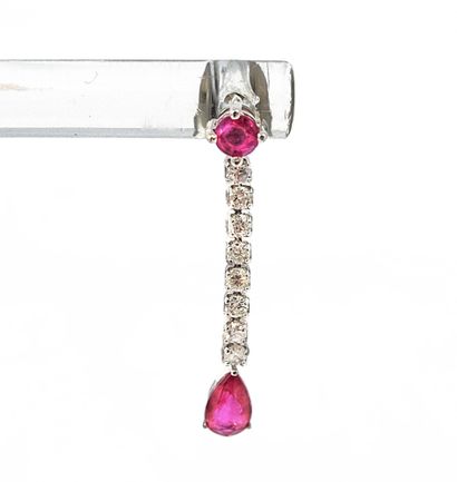 null PAIR OF EARRINGS adorned with a round ruby holding a line of paved diamonds...