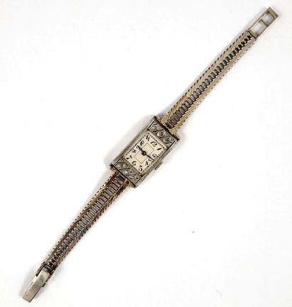 WATCH holding a rectangular dial decorated...