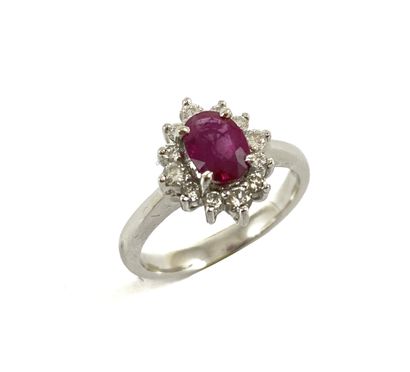 RING holding an oval ruby of approximately...