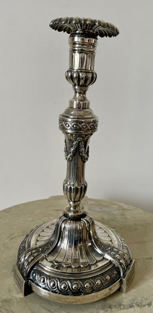 null PAIR OF silver FLAMPS, the circular base chiseled with a frieze of ovals, the...