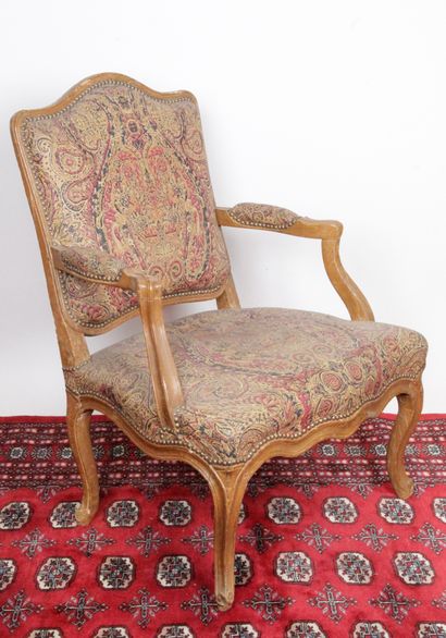 null Louis XV period armchair with flat back in natural wood, molded and carved with...