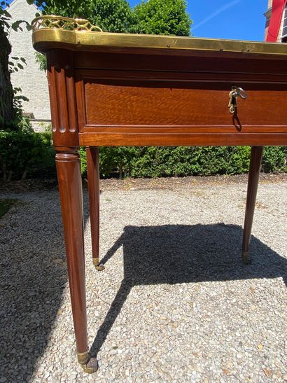 null WRITING TABLE in mahogany opening with a drawer in the waist and resting on...