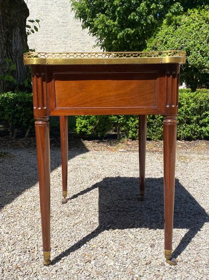 null WRITING TABLE in mahogany opening with a drawer in the waist and resting on...
