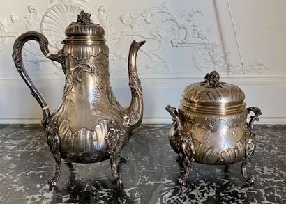 null A silver chased and embossed teapot and sugar bowl with floral decoration. Minerve...