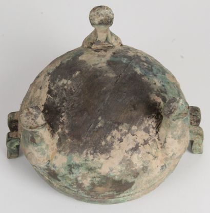  China, early Han period or style. A tripod bronze ding vase with a green and earthy...