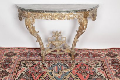 null LARGE CONSOLE of half-moon shape, in gilded wood, molded and carved, of ribbon...