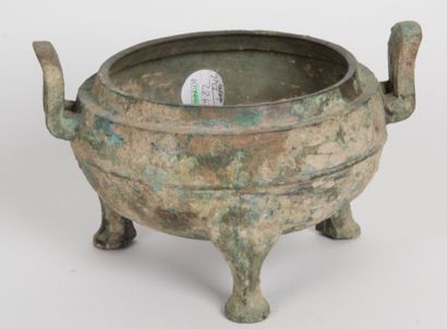 null China, early Han period or style. A tripod bronze ding vase with a green and...