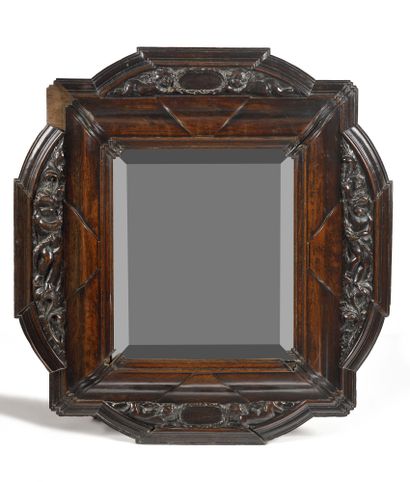 null RARE FRAME in carved and molded walnut with a scalloped shape and decorated...