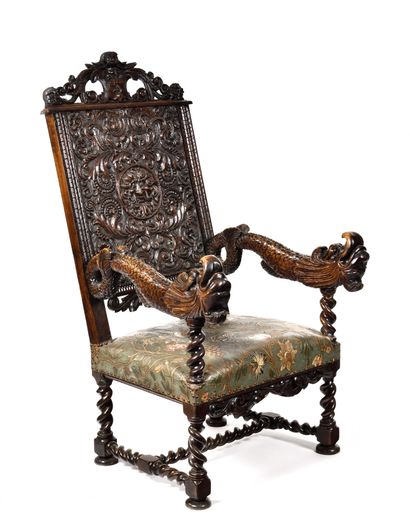 A richly carved walnut armchair. Twisted...