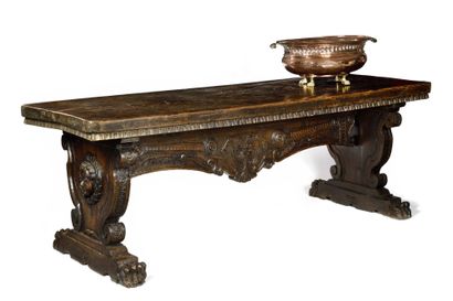 LARGE TABLE in carved walnut. Feet in scrolled...