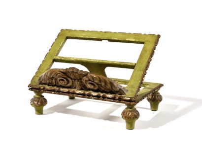 null A carved wood, green and gilded monochrome LUTRIN with foliage decoration resting...