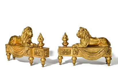 null Pair of chased and gilded bronze LION CHENETS, resting on a base decorated with...