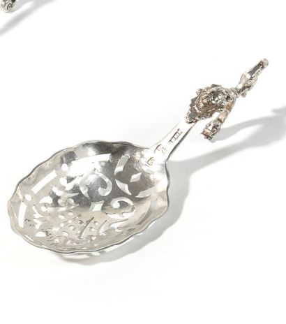 null Spoon in silver of oval form, the handle curved underlined by a mascaron and...
