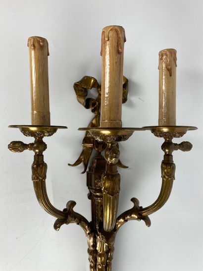 null Suite of FOUR ormolu and varnished sconces with three moving light arms decorated...