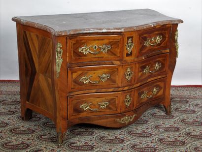 A rosewood veneered chest of drawers with...