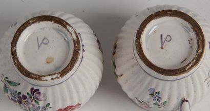 null LOT OF FAIENCE : - A plate with a curved edge and polychrome decoration of flowers....