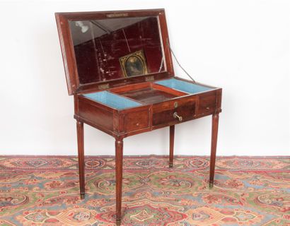 null A man's mahogany COIFFEUSE opening with two drawers in the waist, a tray revealing...