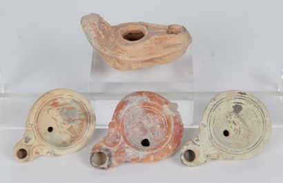 null FOUR OIL LAMPS from the Roman period, Mediterranean area: - THREE LAMPS with...