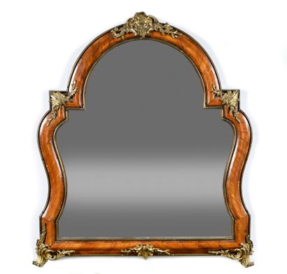 A violet wood and ormolu mirror of arched...