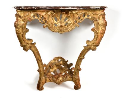 null A carved and gilded wood console table richly carved with rocaille and staples,...