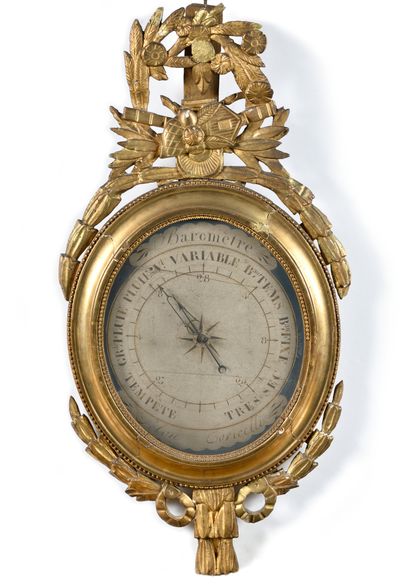 null BAROMETER in carved wood with a trophy and laurel leaves, ribbon knot. The dial...