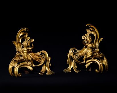 null LARGE PAIR OF ROCKET CHENETS in gilded and chased bronze decorated with crowned...