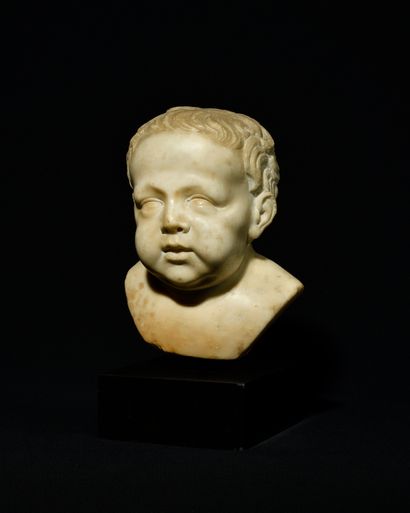  CHILD'S BUST in carved Carrara marble. Base in green marble of Sweden. Italy, 17th...