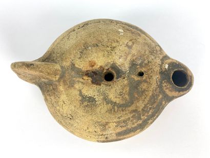  Oil lamp with heart-shaped spout and medallion decorated with busts of Isis and...