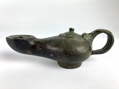 null Oil lamp with circular spout and movable lid Bronze with a smooth black patina....