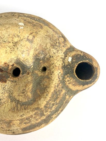 null Oil lamp with heart-shaped spout and medallion decorated with busts of Isis...