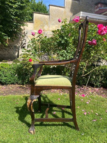 null An armchair in stained and gilded wood with a high carved and openwork back,...