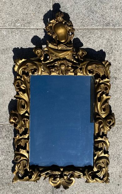 Gilded and molded wood mirror with foliage...