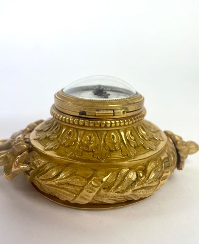 null SMALL ALCOVE CARTEL of circular form in gilded bronze and chased with foliage....