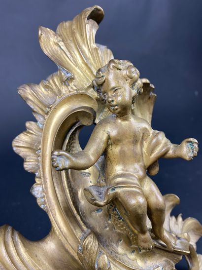 null A gilt bronze and patinated fireplace mantelpiece decorated with cherubs on...