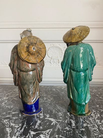 null VIETNAM Two enamelled polychrome stoneware fishermen. Early 20th century. H:...