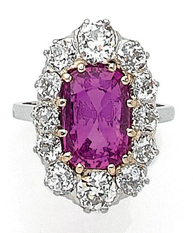 MARQUISE RING holding a cushion ruby of approximately...