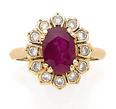 null RING holding an oval ruby of approximately 2.00 carats in a setting of brilliant-cut...