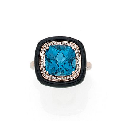 Art Deco style ring holding a faceted topaz...