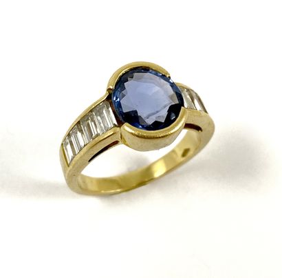 null RING holding an oval sapphire of approximately 2.30 carats with baguette diamonds....