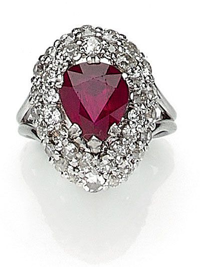  RING holding a pear-shaped ruby of approximately 2.40 carats in a double setting...