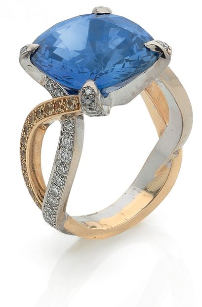 null RING holding a cushion sapphire of 11.31 carats. The body of the ring is composed...
