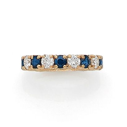 null ALLIANCE alternating brilliant cut diamonds and sapphires. Set in 18K yellow...