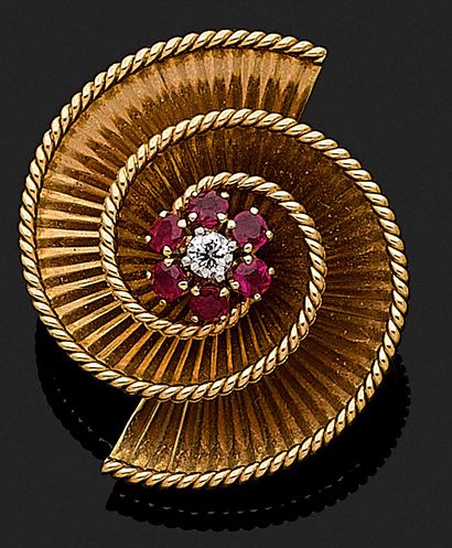 null Spiral brooch holding a flower paved with a brilliant-cut diamond and rubies....