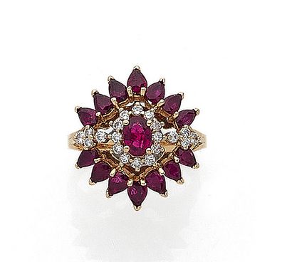  RING with floral design holding in its center an oval ruby in a surround of brilliant-cut...