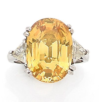 RING holding a yellow sapphire of approximately...