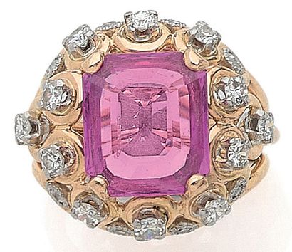 RING holding a floral design with a pink...