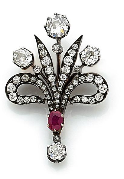 null BRACKET holding a plant design composed of old cut diamonds and an oval ruby....