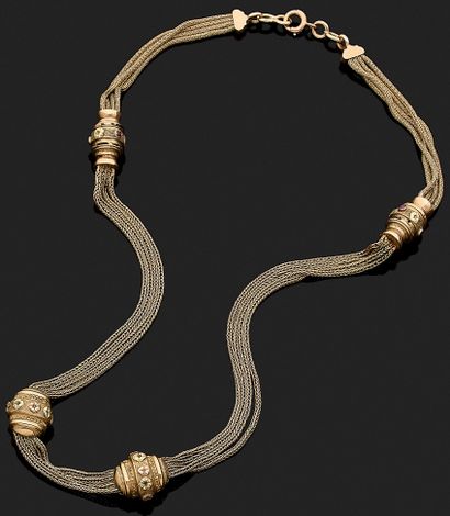 NECKLACE composed of four chains punctuated...